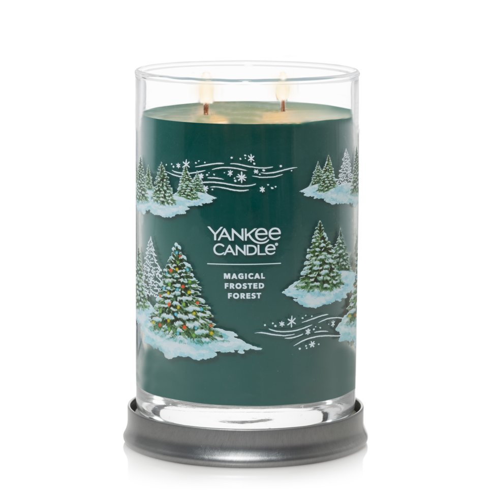 burning magical frosted forest signature large tumbler candle on lid as tray