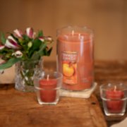 spiced pumpkin large tumbler candle and samplers votive candles on table image number 2