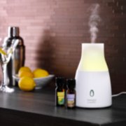 ultrasonic diffuser with lemon lavender and sicilian lemon diffuser blends on desk image number 1