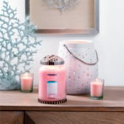 pink sands samplers votive candles on candle holder and pink sands large jar candle with illuma lid on table image number 5