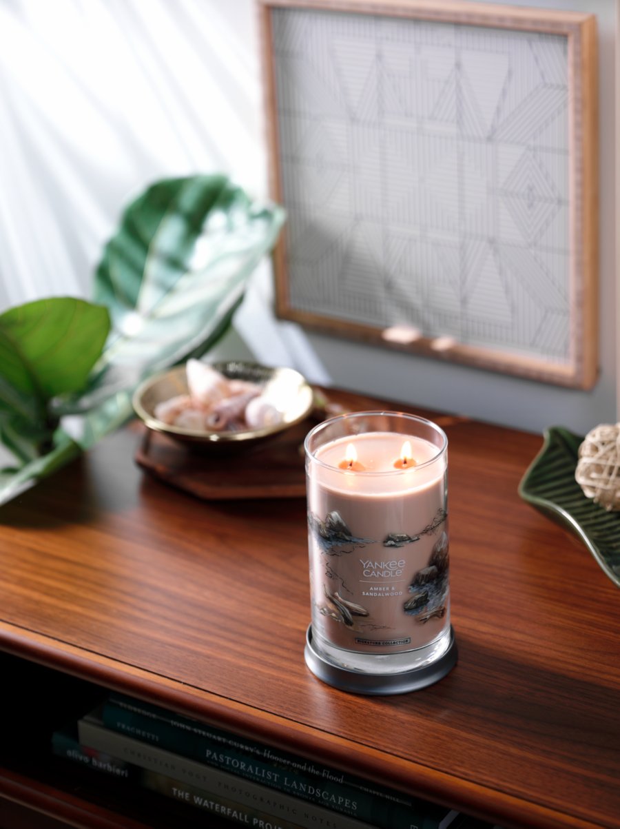 amber and sandalwood signature large tumbler candle on desk