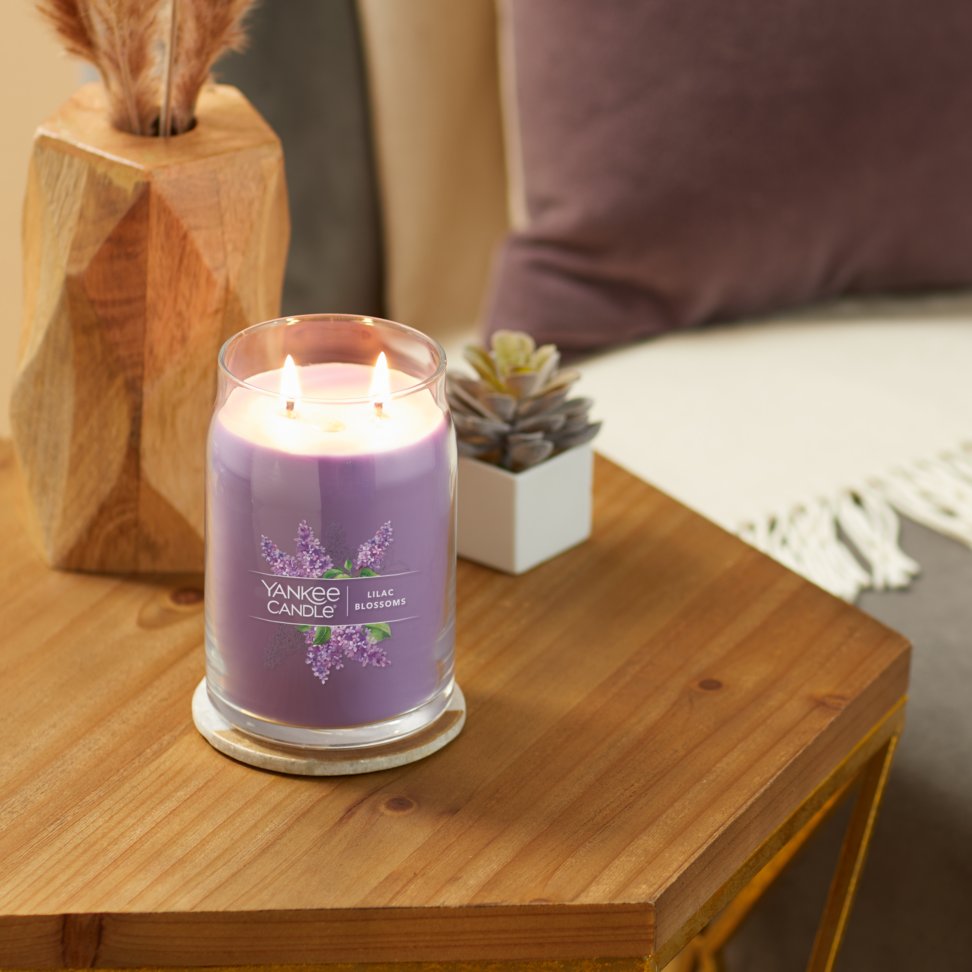 lilac blossoms signature large jar candle on table