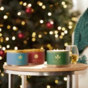 north pole, sparkling cinnamon, and balsam and cedar three-wick candles on table image number 4