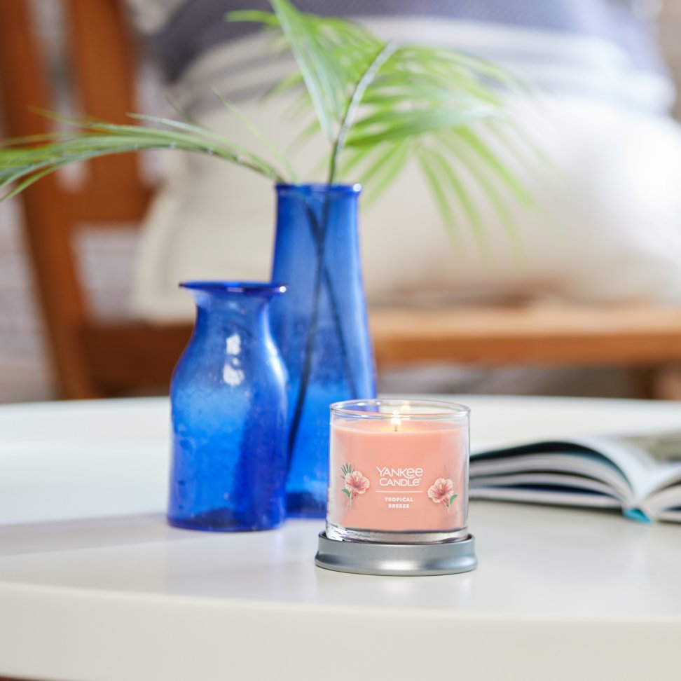 tropical breeze signature small tumbler candle on table