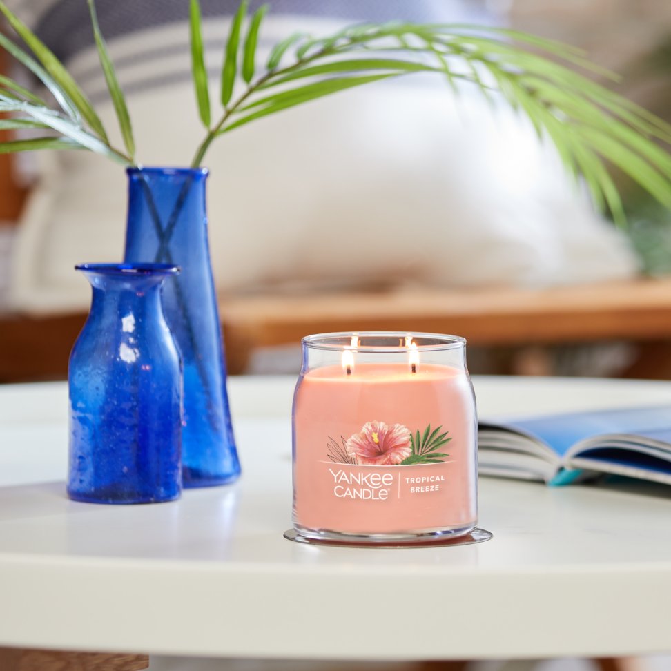 tropical breeze signature medium jar candle on table