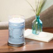 life's a breeze signature large tumbler candle on table in living room image number 4