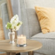 vanilla cupcake signature small tumbler candle on table image number 4