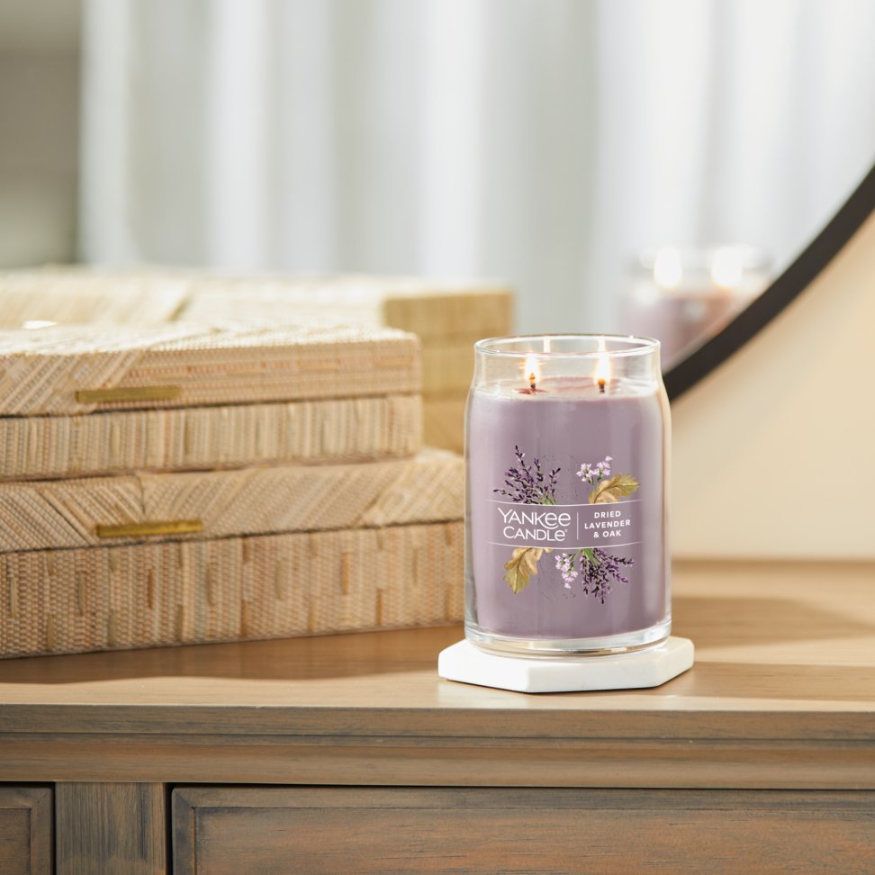 dried lavender and oak signature large jar candle on table