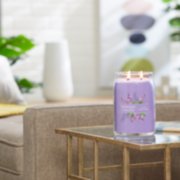 lilac blossoms signature large jar candle lit on side table image number 6