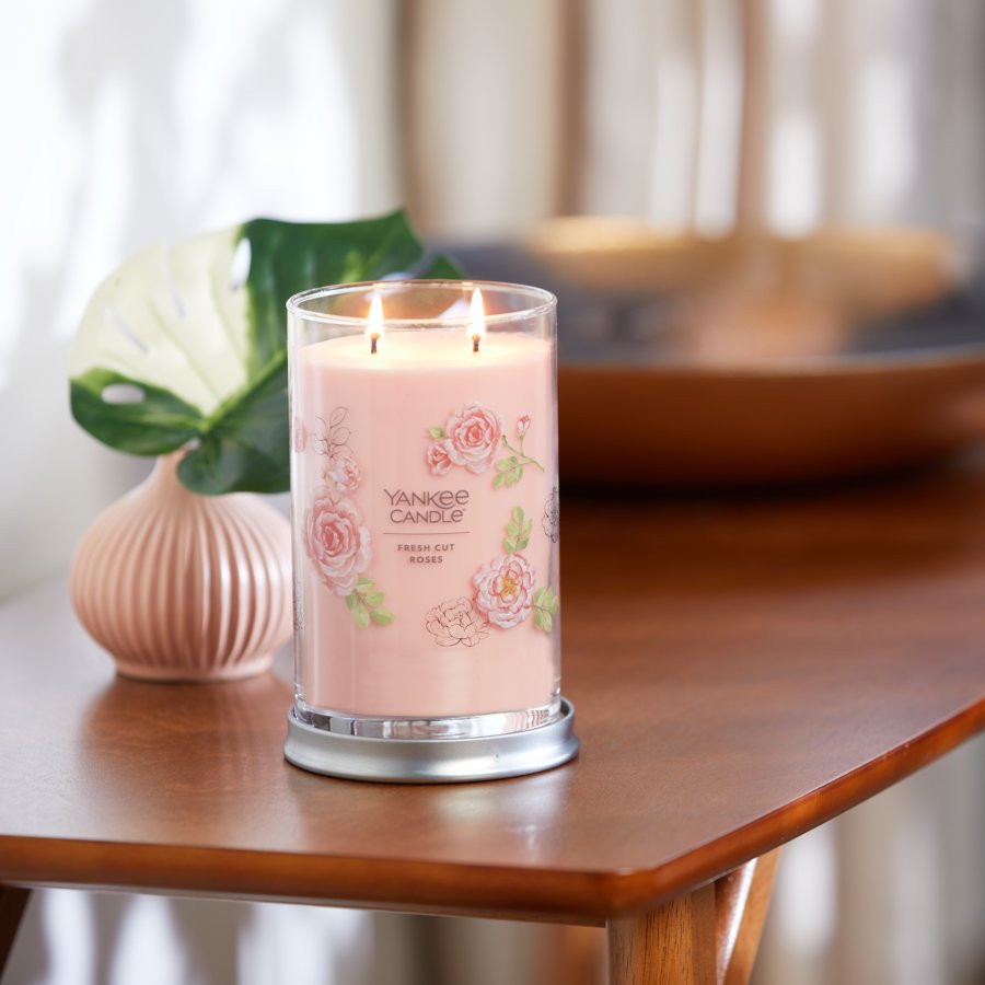 fresh cut roses signature large tumbler candle on side table