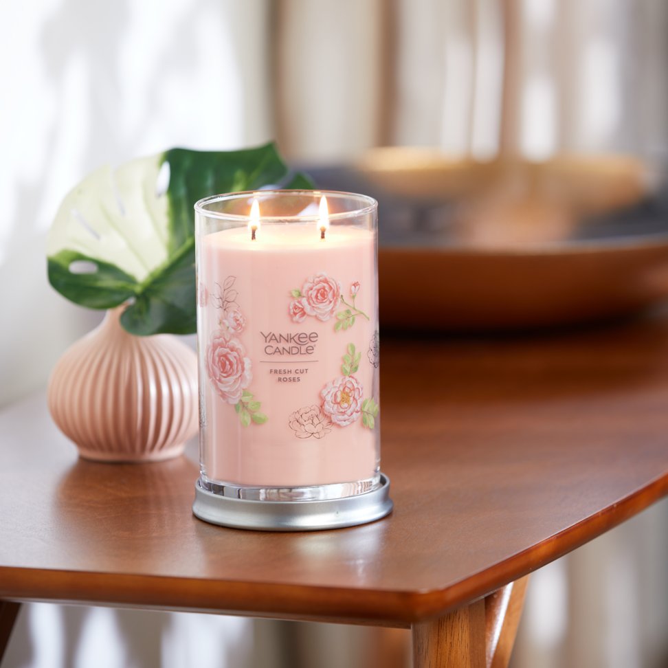fresh cut roses signature large tumbler candle on side table