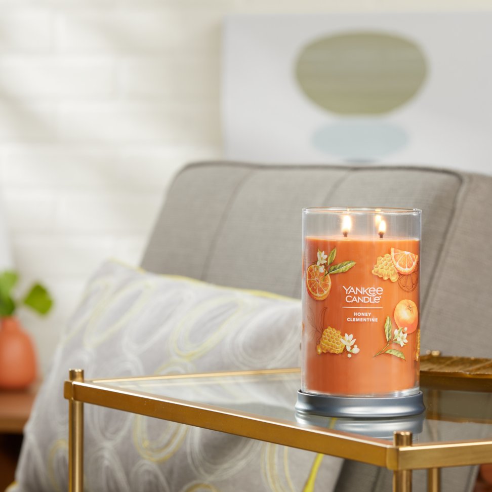 honey clementine signature large tumbler candle lit on side table