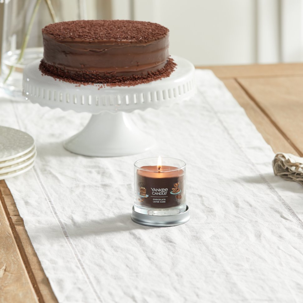 chocolate layer cake signature small tumbler candle on table