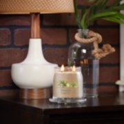 sun and sand signature medium jar candle on table image number 4
