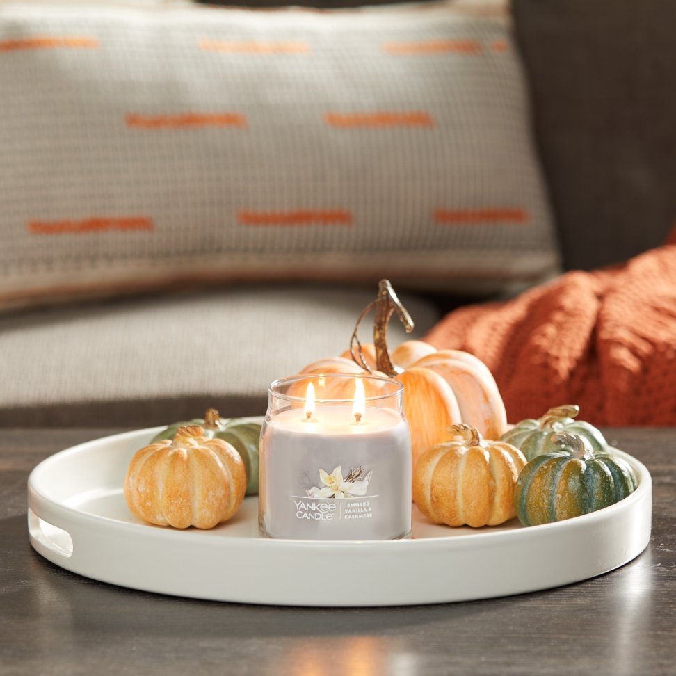 smoked vanilla and cashmere signature medium jar candle on tray in living room