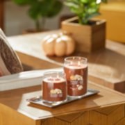 pumpkin banana scone signature large and medium jar candles on table in living room image number 7