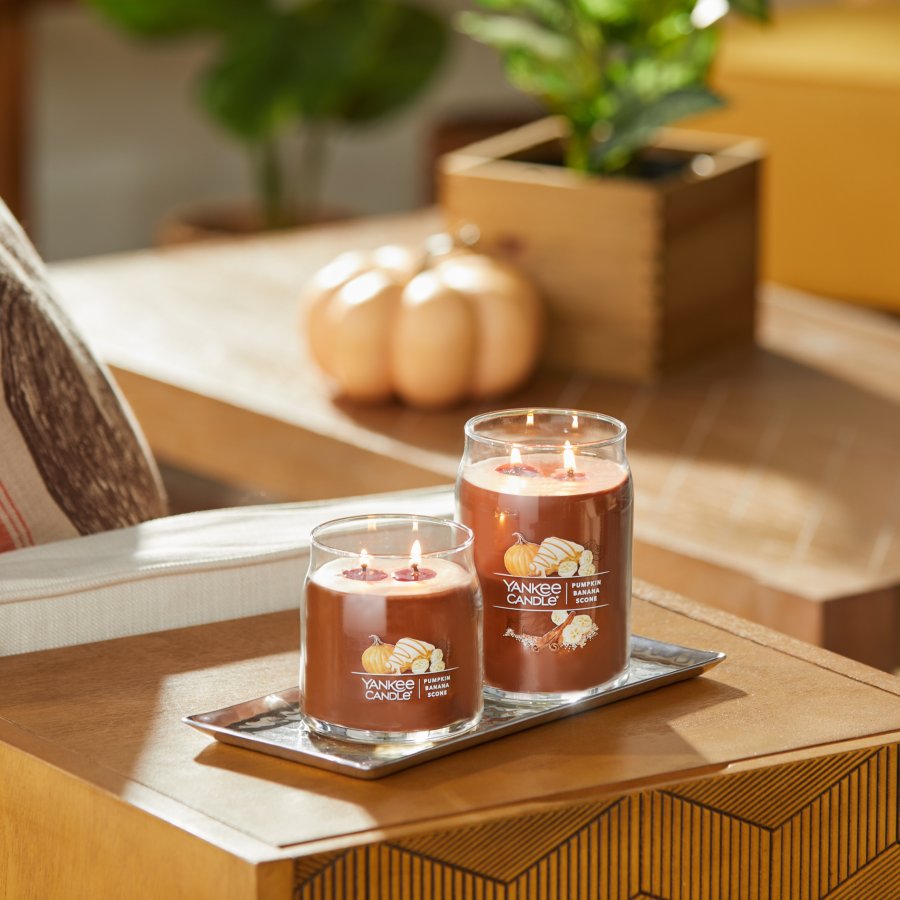 pumpkin banana scone signature large and medium jar candles on table in living room