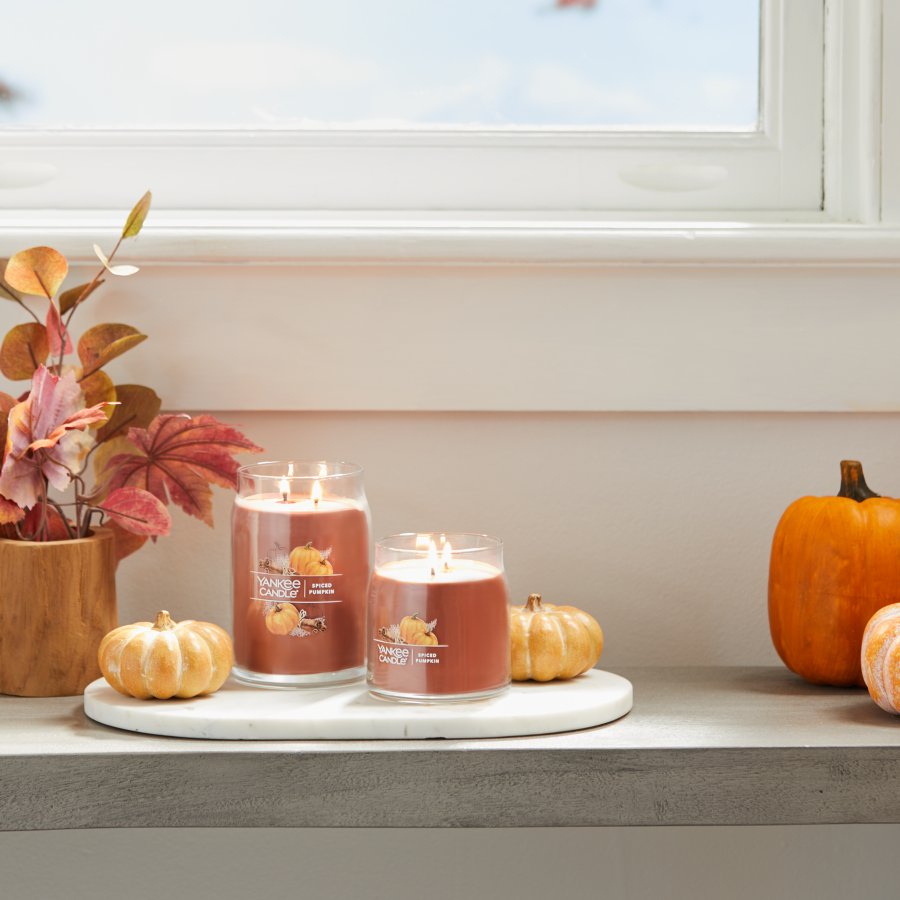 spiced pumpkin signature large and medium jar candles on table