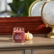 cranberry chutney signature medium jar candle on table image number 3