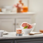 farm fresh peach signature small tumbler candle on kitchen counter image number 3