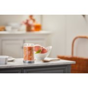 farm fresh peach signature large tumbler candle on kitchen counter image number 1