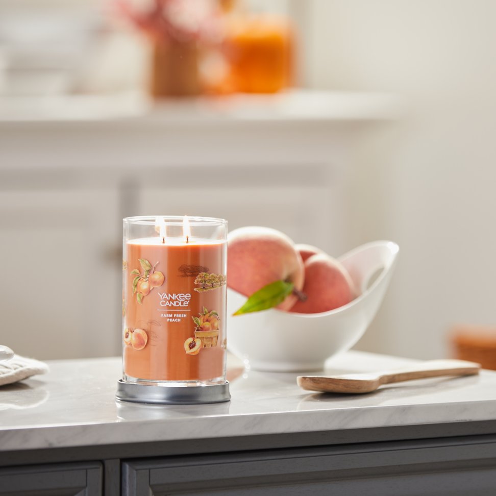 farm fresh peach signature large tumbler candle on kitchen counter