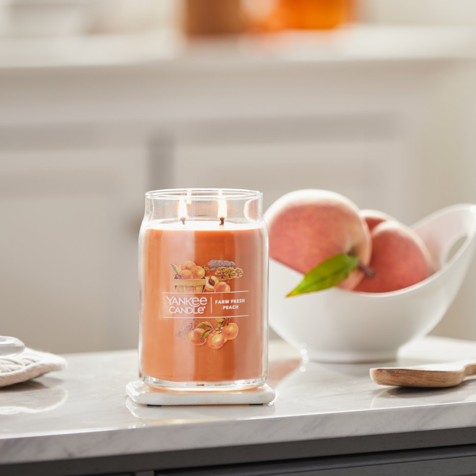 farm fresh peach signature large jar candle on kitchen counter