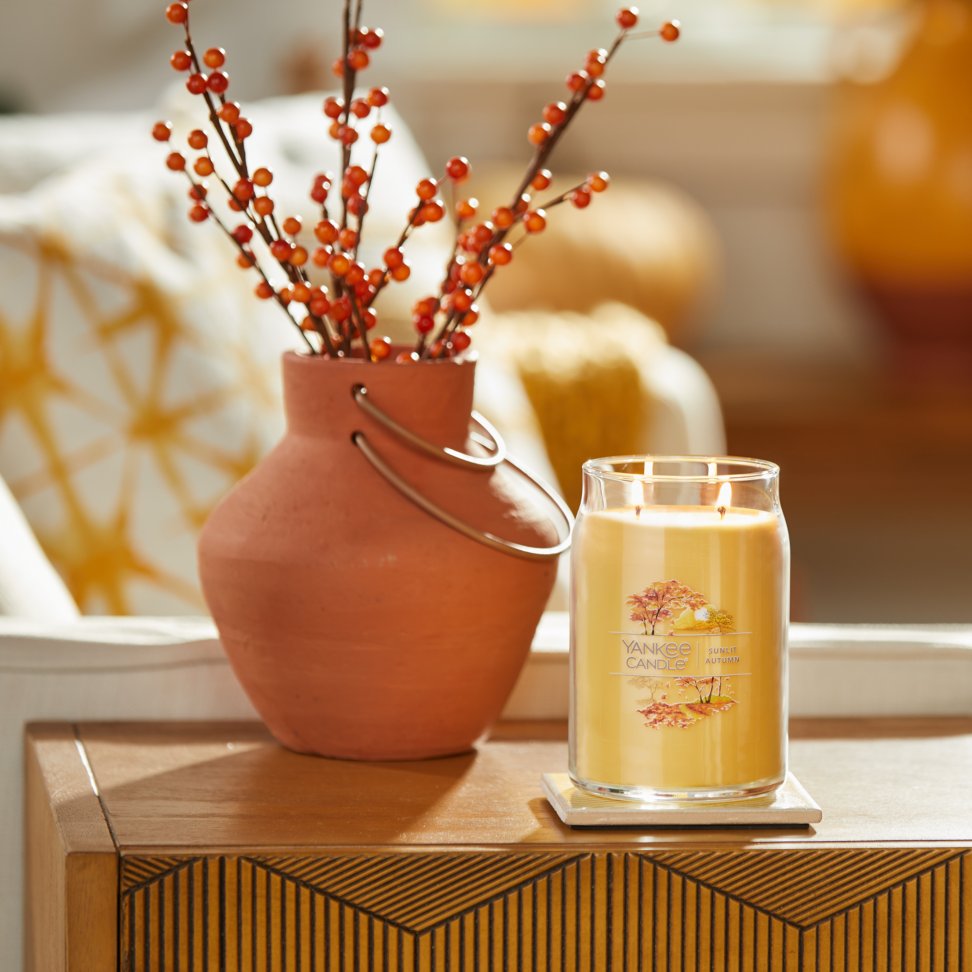 sunlit autumn signature large jar candle on table