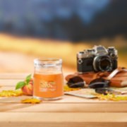 farm fresh peach signature medium jar candle on table image number 6