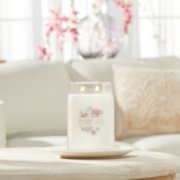 sakura blossom festival signature large jar candle on living room table image number 4