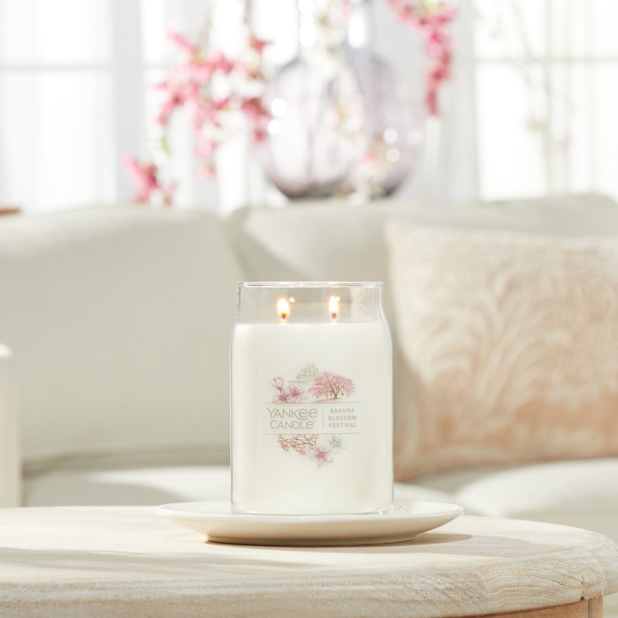 sakura blossom festival signature large jar candle on living room table