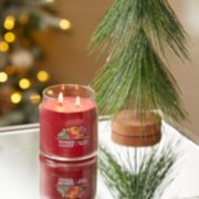 red apple wreath signature medium jar candle on table image number 4