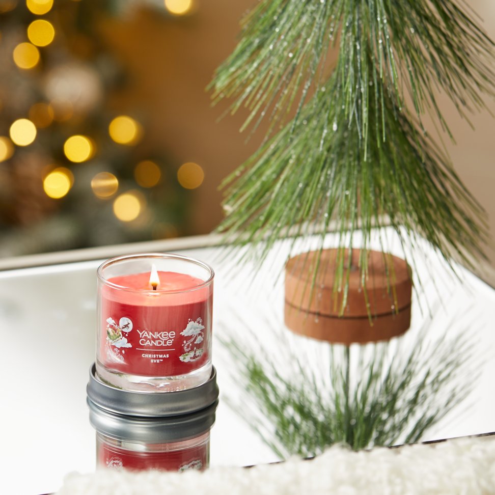 christmas eve signature small tumbler candle on table
