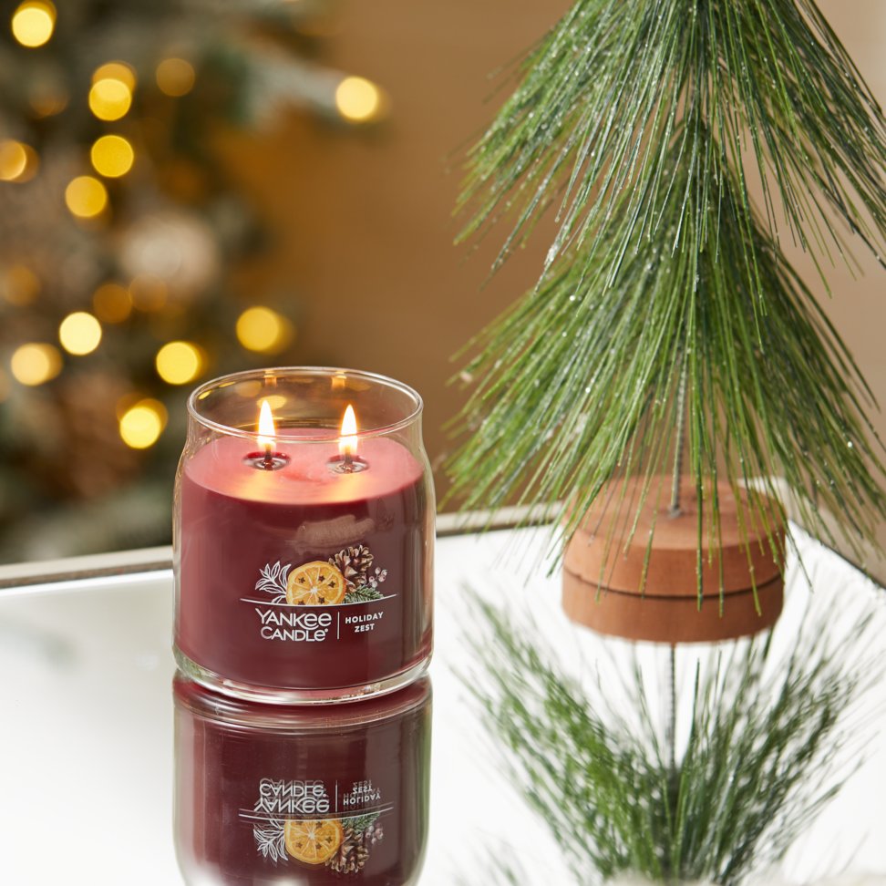 holiday zest signature medium jar candle on table