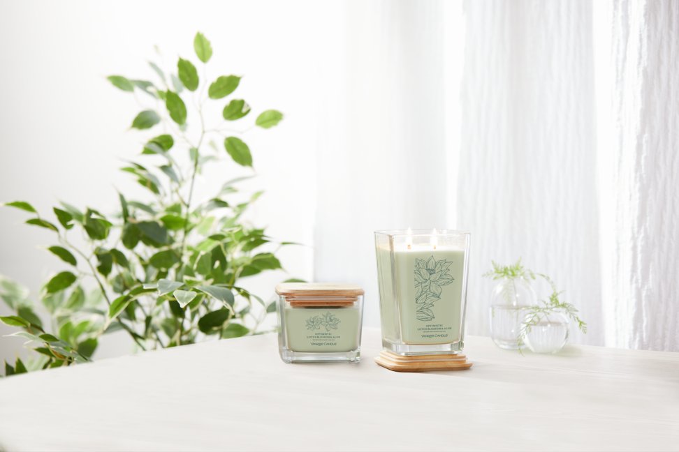 well living collection optimistic lotus blossom and aloe large square candle and small square candle on table