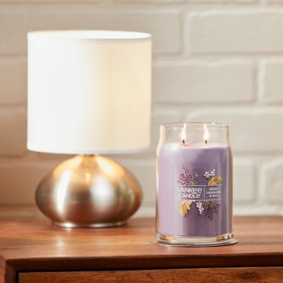dried lavender and oak signature large jar candle on table