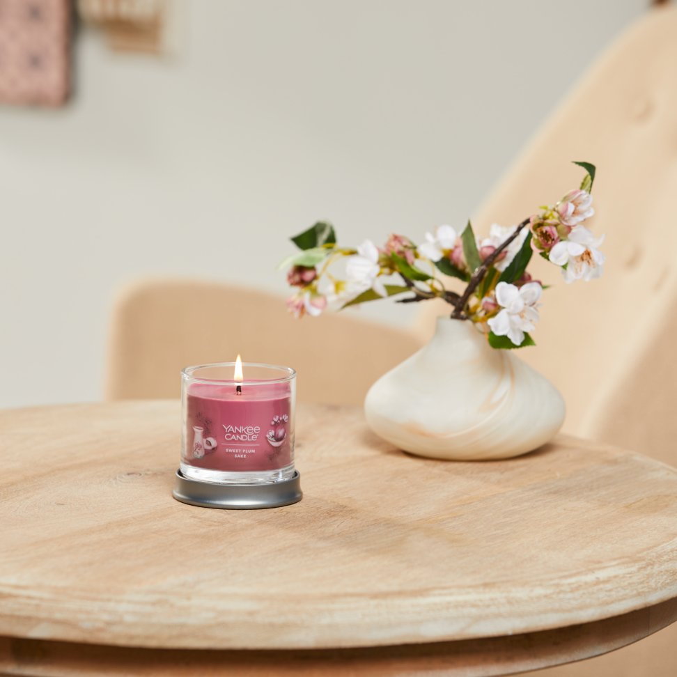 sweet plum sake signature small tumbler candle on table