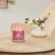 sweet plum sake signature medium jar candle on table image number 4