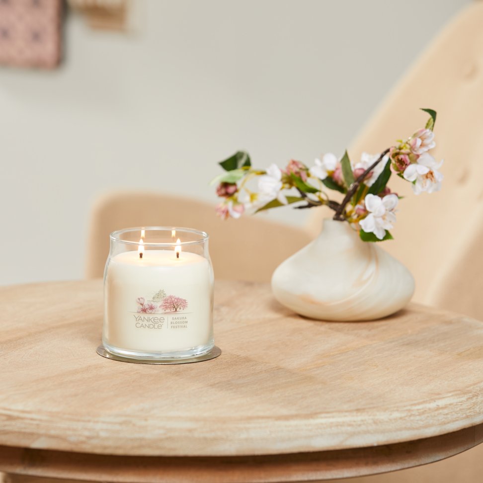 sakura blossom festival signature medium jar candle on table