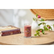 lit home sweet home signature medium pillar candle on wooden table next to books and roses image number 4