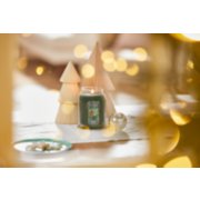 balsam and cedar original large jar candle on a table next to wooden decorative trees image number 5