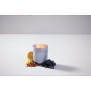 chesapeake bay candle intentions collection be confident indigo poppy medium two wick jar candle surrounded by blueberries and lemon slices in a pastel purple backdrop image number 6
