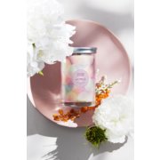 wonder signature large tumbler candle 2023 scent of the year surrounded by flowers image number 3