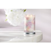 wonder signature large tumbler candle 2023 scent of the year on a white table next to a white flower image number 6