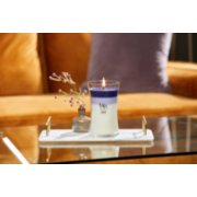 purple trilogy large hourglass candle on stone tray with small vase and flowers on glass coffee table image number 4
