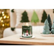 balsam and cedar large jar candle with wintery gnome label and evergreen decor on wood table image number 3