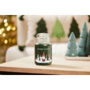 balsam and cedar large jar candle with wintery gnome label and evergreen decor on wood table image number 4