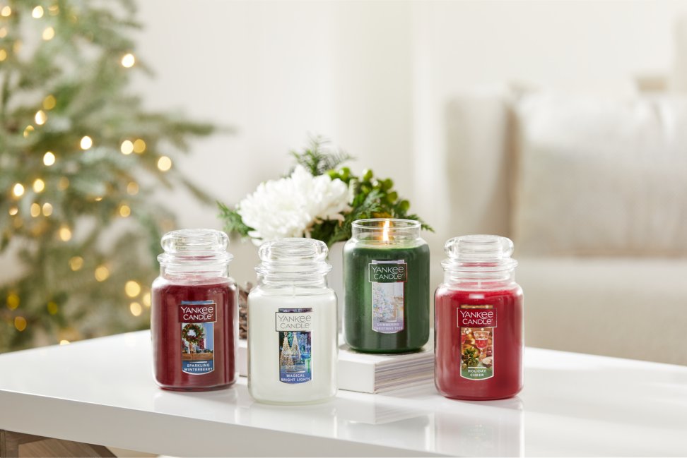 sparkling winterberry original large jar candle, magical bright lights original large jar candle, shimmering christmas tree original large jar candle, and a holiday cheer original large jar candle on a white table
