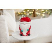 santa gnome jar candle holder on a white table next to a white couch image number 4