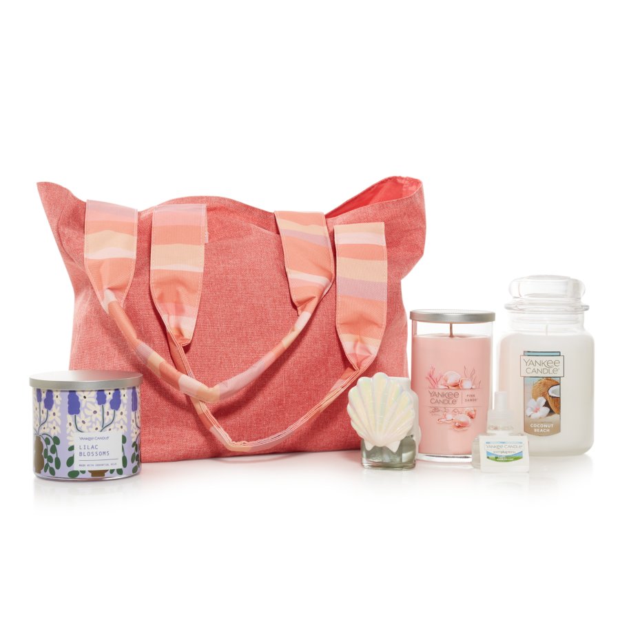 the Spring Fragrance Tote featuring a Lilac Blossoms 3-Wick Candle, Seashell ScentPlug® Diffuser, Pink Sands™ Signature Medium Pillar Candle, a Clean Cotton® ScentPlug® Refill, and a Coconut Beach Original Large Jar Candle